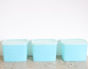 Three vintage Tupperware storage containers from the seventies