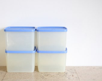 Four vintage Tupperware storage containers from the seventies