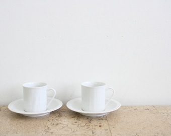 Two white porcelain Royal Porcelain Cannelee or Series 2075 Secunda coffee cups and saucers