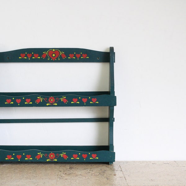 Vintage green wooden spice rack with painted hearts and flowers