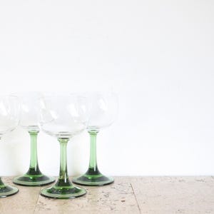 Four vintage wine glasses with green base from the seventies