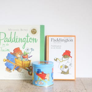 Vintage Paddington candy tin and two Dutch books, one from Douwe Egberts in Holland