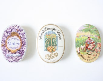 Three vintage oval candy tins from the eighties