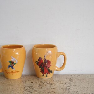 Yellow Efteling Chocomel cup, de enige echte by Nutricia, with Ravelijn knight Thomas and the wolf and the seven little goats.