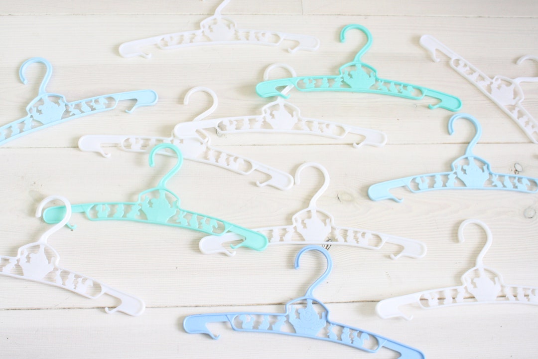 10 or 12 vintage baby clothes hangers from the seventies in white or