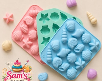 May include: Three rectangular silicone moulds in pink, mint green, and light blue, each featuring various seashell and starfish cavities. Several moulded seashell and starfish shapes in pink, blue, cream, and purple are scattered around the moulds.