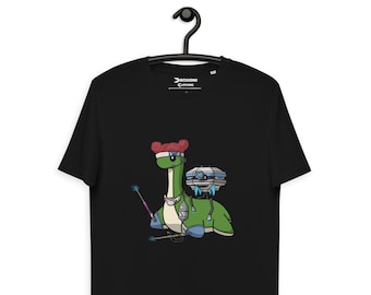 May include: Black t-shirt with a green dinosaur wearing a blue headband and holding a wand. The dinosaur has a pink bow on its head and is carrying a white and blue backpack.