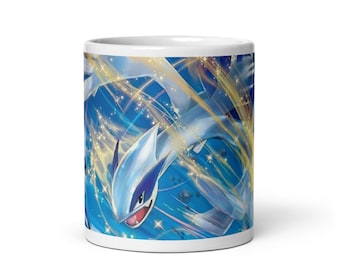 May include: White ceramic mug featuring a vibrant illustration of a blue and white mythical creature with a red mouth, set against a dynamic blue and gold background. The design wraps around the mug, showcasing the creature in flight.