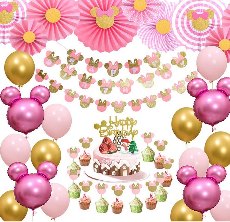 May include: Pink and gold Minnie Mouse themed birthday party decorations. The decorations include balloons, a banner, cupcake toppers, and a cake topper. The banner says "Happy Birthday".
