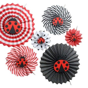 May include: Set of six paper fan decorations with ladybug designs. The fans are in red and white stripes, black and white stripes, and black and white polka dots.