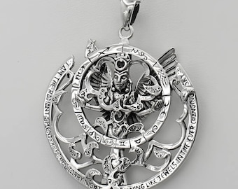 May include: A silver pendant featuring a detailed design of a celestial figure with wings, surrounded by a circular frame with zodiac symbols and the inscription "I AM THE RADIANT SPLENDOR OF THE STARRY-NIGHT SHINING LIKE JEWELS IN THE EVER CHANGING SKY".
