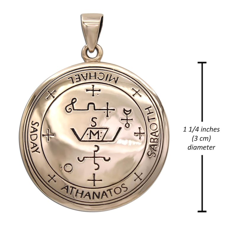 May include: A circular pendant with etched symbols and text, including "MICHAEL" and "ATHANATOS". The pendant is approximately 1 1/4 inches in diameter. It has a loop at the top for a chain.