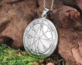 May include: Silver pendant necklace with a circular design featuring a star of David, Hebrew text, and a geometric pattern. The pendant is on a silver chain.