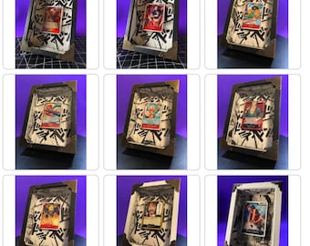 May include: Nine black and white shadow boxes with gold accents, each displaying a different anime character card. The shadow boxes are displayed on a purple background.