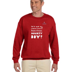 May include: A red sweatshirt with the text "It's not my, geddamn planet! Understand, MONKEY BOY?" in white. The sweatshirt has a crew neck and long sleeves. A small logo is visible on the upper right chest.