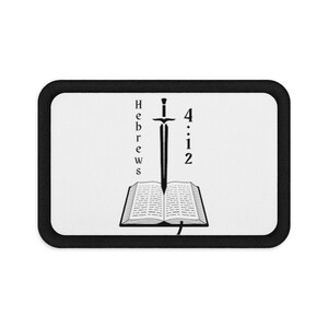 May include: A rectangular patch with a white center and a thick black border. The design features an open book with a sword pointing downward into the center of the pages. The text "Hebrews" is printed vertically on the left and "4:12" on the right.
