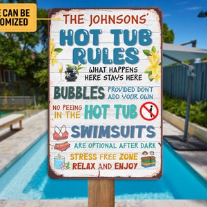 May include: A rectangular metal sign on a wooden post with the text "The Johnsons' Hot Tub Rules". The sign has a distressed, rustic look with a white background and colorful text. It includes rules and decorative elements.
