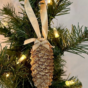 Champagne Gold Pinecone Ornaments with your choice of a Beautiful Gold Ribbon and Matching Gold Mini Bow or Cream Ribbon and Cream Mini Bow!