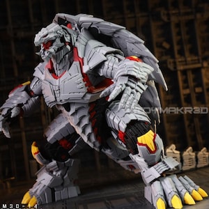 May include: A detailed, articulated action figure in a dynamic pose. The figure is primarily gray with red and yellow accents, featuring intricate armor-like detailing. The figure's design suggests a robotic or monster-like character.