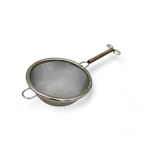 May include: A silver tea infuser with a mesh strainer and a long handle. The handle has a loop at the end for easy gripping.