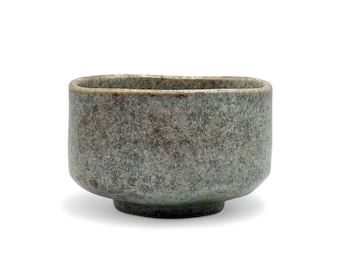 May include: A gray ceramic teacup with a speckled glaze. The cup has a rounded shape and a wide rim.