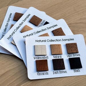May include: Cork samples in various shades of brown, including whitewashed, natural, light brown, cinnamon, dark brown, and black. The samples are labeled with their corresponding color names.