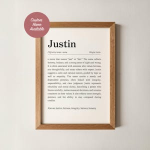 May include: A wooden framed print featuring the name "Justin" and its definition. The text describes the name's origin, pronunciation, and associated characteristics. A circular sticker in the top left corner says "Custom Name Available."