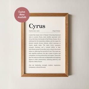 May include: A framed print featuring the name "Cyrus" with its origin and meaning. The text describes the name's historical roots and positive attributes. A circular sticker in the top left corner says "Custom Name Available."