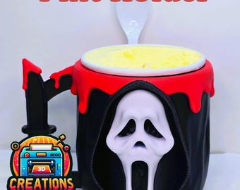 May include: A black ice cream pint holder featuring the Ghostface mask from the Scream movies. The holder has a red rim with dripping paint, a black handle, and a white spoon. The text "Ghostface Ice Cream Pint Holder" is at the top.