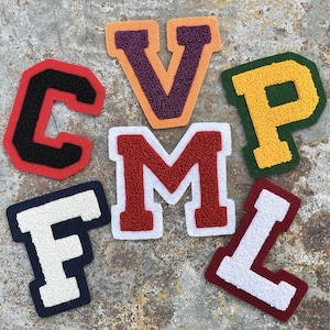 May include: A set of felt letter patches in various colors, including red, white, black, blue, green, yellow, orange, and purple. The letters are C, V, P, M, F, and L.