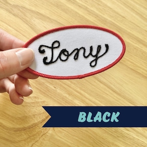 May include: White oval-shaped patch with a red border. The patch has the word "Tony" embroidered in black cursive lettering.