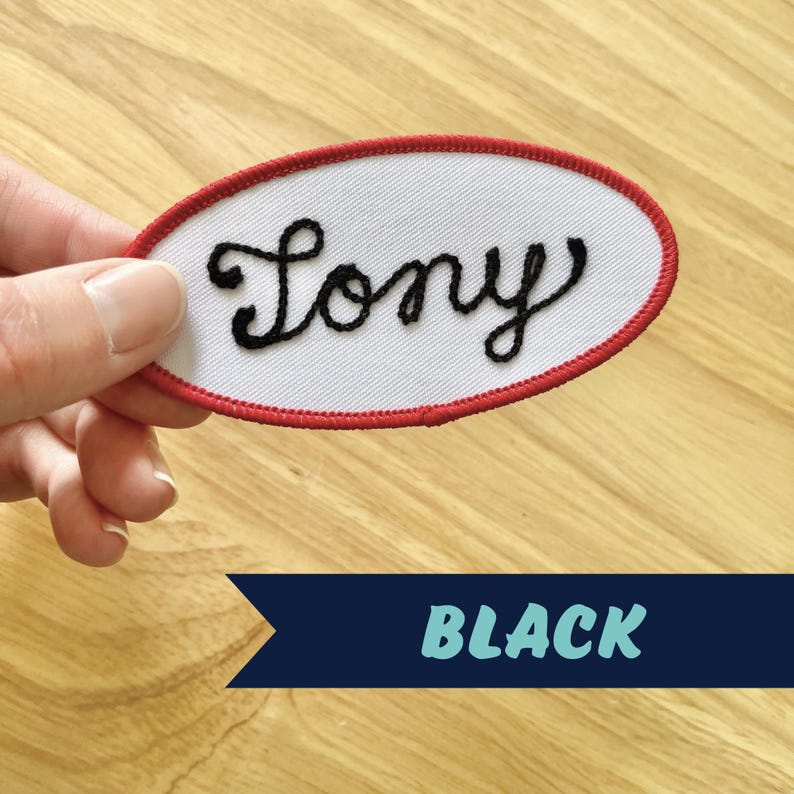 May include: White oval-shaped patch with a red border. The patch has the word "Tony" embroidered in black cursive lettering.