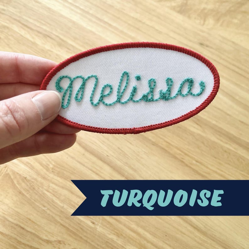 May include: Turquoise embroidered name patch with the name "Melissa" in a white oval with a red border.