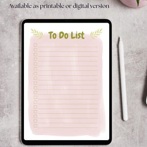 Könnte beinhalten: Eine digitale To-Do-Liste auf einem Tablet-Bildschirm mit einem rosa Aquarellhintergrund und goldenen Linien. Der Text "To Do List" ist in fetter, grüner Schrift mit Blattverzierungen geschrieben.
