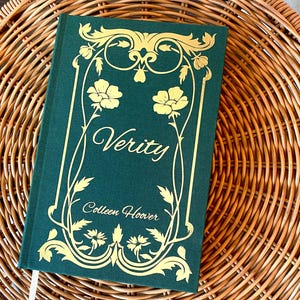 May include: A green hardcover book with a gold floral design and the title "Verity" by Colleen Hoover.