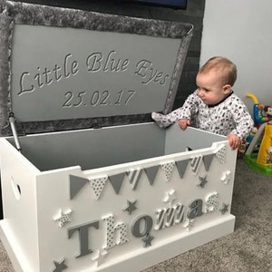 Handmade personalised wooden toy box. Cushioned top with name & decorations in any colour and engraved message with stay up lid.