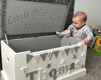 Handmade personalised wooden toy box. Cushioned top with name & decorations in any colour and engraved message with stay up lid.