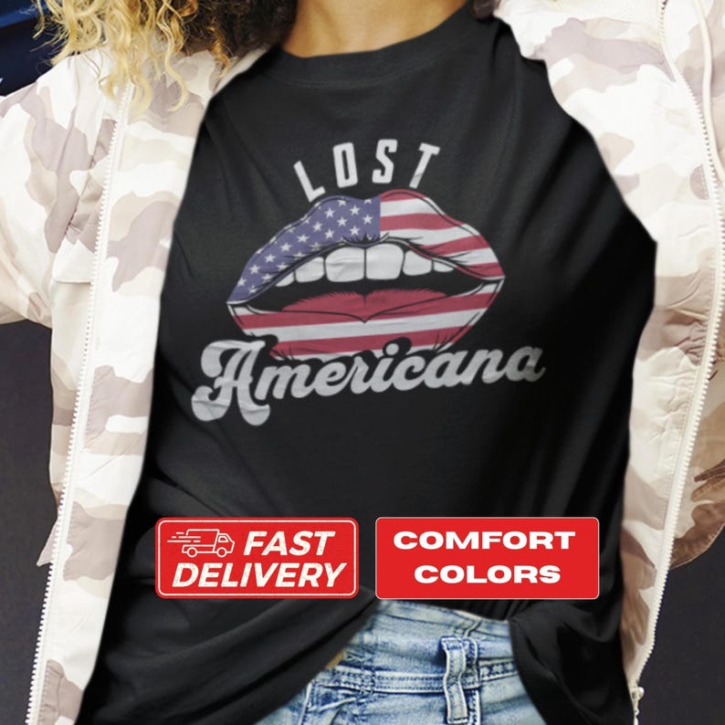 T-shirt design with the phrase “Lost Americana” and a bold graphic of lips printed in an American flag pattern placed between the words.