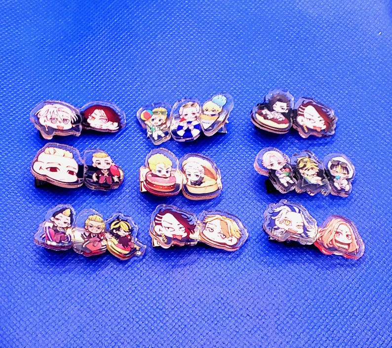 May include: A set of 10 colorful anime character pins. The pins are made of clear plastic and feature various characters from different anime series. The pins are perfect for adding a touch of anime style to your clothing, bags, or other accessories.
