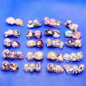 May include: A collection of 20 colorful anime character pins. The pins are made of clear acrylic and feature various characters from popular anime series. The pins are arranged in rows on a blue surface.