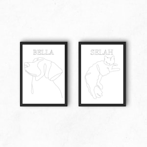 Può includere: Due stampe incorniciate nere con sfondi bianchi. La stampa a sinistra presenta un disegno a linea di una testa di cane con il nome "BELLA" sopra. La stampa a destra presenta un disegno a linea di un gatto rannicchiato con il nome "SELAH" sopra.