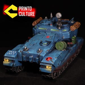 May include: A detailed, blue model tank with the text "FAKE TAXI" on the front. The model has a weathered appearance with red accents and various details like a gun turret and storage. The logo "PRINTO CULTURE" is in the top left.