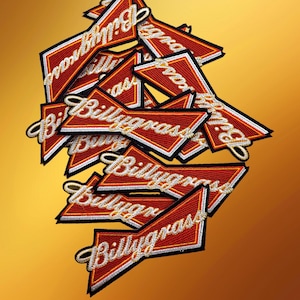 May include: A collection of embroidered patches with a red, white, and black design. The patches feature the word "Billygrass" in a stylized, cursive font. The patches are arranged on a gradient yellow background.