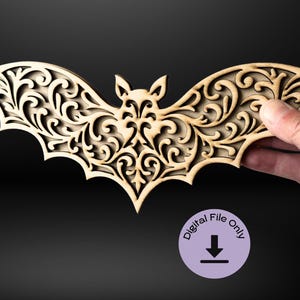 May include: A wooden bat silhouette with intricate cut-out designs. The bat is made of light brown wood and has a delicate, ornate pattern.