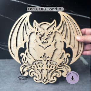 May include: A laser-cut wooden gargoyle design with outstretched wings, intricate details, and a decorative base. The text "SVG, DXF, and AI" is at the top, and "Whimsy Spark Creations" is at the bottom. A purple circle with the text "Digital File Only" is on the right.
