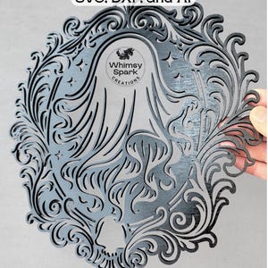 May include: Laser-cut, layered artwork in a decorative oval frame. The design features a stylized figure with flowing hair, stars, and ornate scrollwork. The text "SVG, DXF, and AI" is at the top. The artwork includes the "Whimsy Spark Creations" logo.