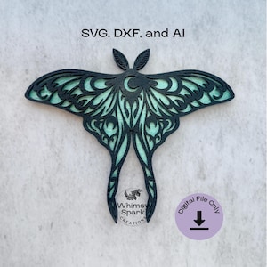 May include: A layered, dark teal moth design with intricate cut-out patterns, set against a light teal background. The image includes the text "SVG, DXF, and AI" and a digital file download icon. The design is from Whimsy Spark Creations.