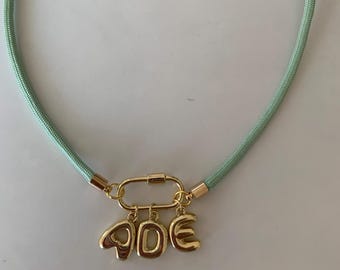 Personalized Matcha Green Paracord Necklace with gold bubble initials. Spring fashion accessory, thoughtful gift