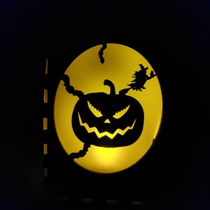 Lantern of a Pumpkin surrounded by Bats and Witches on a Broom Stick for amazing ambience in your home.