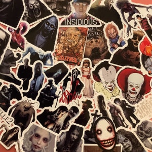 May include: A selection of horror film stickers featuring famous characters and movie titles. The stickers include images of Pennywise, Chucky, and characters from "Insidious" and "Scream". The stickers are on a red background.